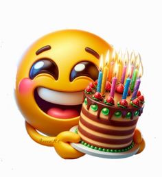 a smiley face holding a birthday cake with candles