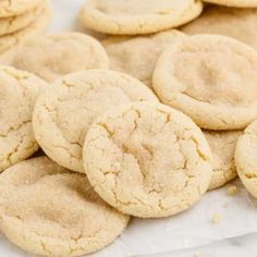 a pile of cookies sitting on top of a white tablecloth covered in powdered sugar