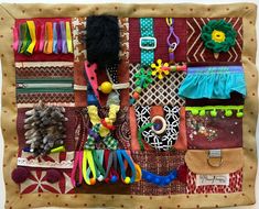 a close up of many different items on a piece of cloth with scissors and beads