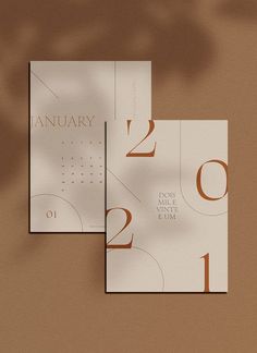 two calendars with numbers on them sitting side by side against a brown wall and floor