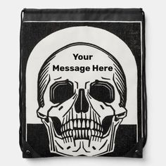 a black and white skull drawsack bag with the message message here on it's front