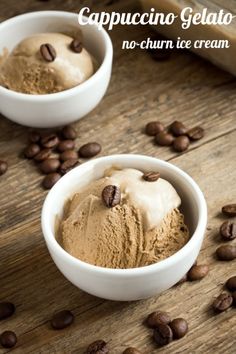 two white bowls filled with ice cream and coffee beans on top of a wooden table