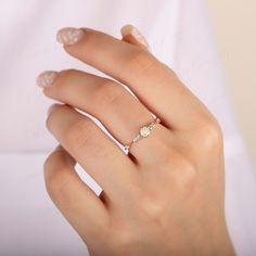 a woman's hand with a ring on it