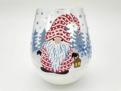 a glass with a painted santa clause on it