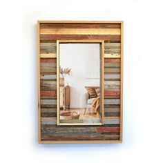 a wooden mirror hanging on the wall