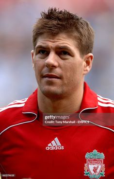 a man in red jersey looking at the camera with serious look on his face stock photo