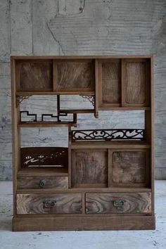 an old wooden shelf with drawers on it