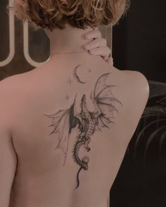 a woman with a dragon tattoo on her back