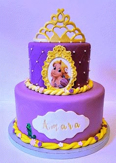 a purple and yellow cake decorated with a princess's face on the top tier