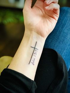 a woman with a cross tattoo on her wrist