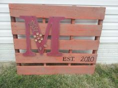 a wooden pallet with the letter m on it