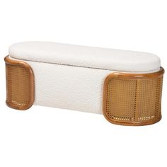 a wooden bench with white cushions and gold trimmings on the back side,