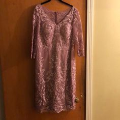 a purple dress hanging on a door