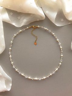 "This necklace features pearlescent, matte clear, white, and 24k gold filled seed beads. It also contains clear crystal beads. As well as faux pearls.  Length: 15\" inches Seed Bead Size: 11/0, 4mm, 6mm Adjustable: Each necklace has a 2.5\" gold filled lobster clasp extender Strung on: Non-Stretchy Beading Thread" Gold Crystal Necklace With Pearl Chain, Adjustable Gold Crystal Necklace For Wedding, Delicate Gold Beaded Crystal Necklace, Delicate Gold Beaded Crystal Necklaces, Aurora Necklace, قلادات متدلية, Seed Bead Choker, Beaded Jewelry Necklaces, Bead Choker