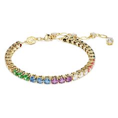 Celebrate your true colors with the joyful styling of this Matrix Tennis bracelet. Fastened with a lobster closure, the gold-tone plated jewelry features a vibrant row of rainbow-colored stones, each placed in a refined prong setting. This jewelry is made for self-expression and can be paired with a matching ring. Multicolor Bracelet, Pink Watch, Swarovski Bracelet, Gold Armband, Matching Ring, Rose Gold Watches, Matching Rings, Single Earring, Metal Bracelets