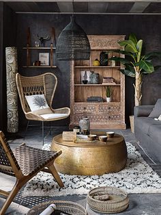 a living room filled with furniture and a large potted plant on top of a table