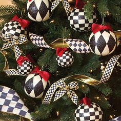 a christmas tree decorated with black and white checkered baubles, ribbons and bows