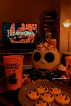 halloween treats are arranged on a table in front of a television