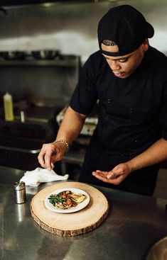 a man standing in front of a plate with food on it