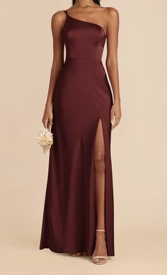 a bridesmaid in a long burgundy dress with one side slit and thigh high split