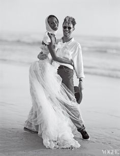 a man holding a woman on the beach