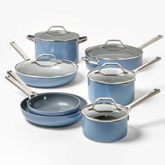 a set of blue pots and pans with lids