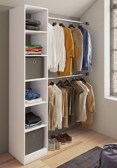 an organized closet with clothes and shoes hanging on the rails, in front of a window