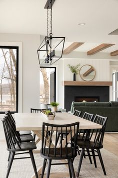 the dining room table is surrounded by black chairs