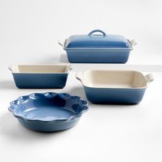 three blue dishes and one white bowl