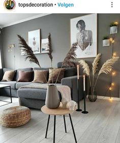 a living room filled with furniture next to a window covered in lights and decor items