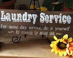 a wooden sign that says laundry service for same day service, do it yourself