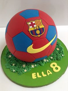 a soccer ball cake on top of a green plate