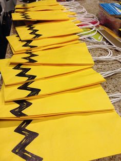 yellow paper with black letters are lined up on the floor next to wires and cords