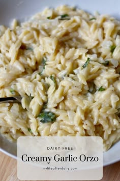 a white bowl filled with creamy garlic orzo