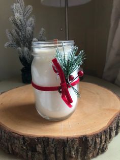 a glass jar filled with white liquid sitting on top of a tree stump