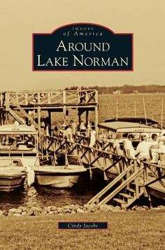 the cover of around lake norman, with several small boats docked in front of it