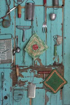 an assortment of kitchen utensils hanging on a wall