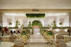 an indoor wedding venue with tables and chairs set up for the guests to sit down