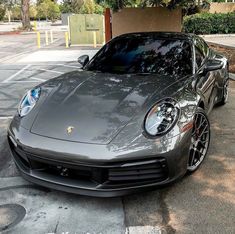 a black sports car parked in front of a parking meter