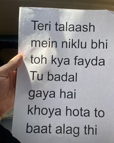 a person holding up a piece of paper with the words written on it in different languages