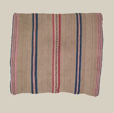 an old rug with stripes on the bottom and blue, red, and white stripes