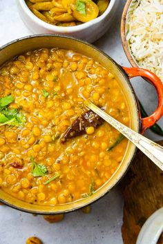 two bowls filled with beans and rice on top of a table