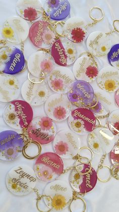 a bunch of personalized key chains with flowers on them