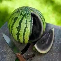 a watermelon cut in half with a knife