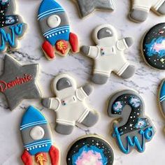 some cookies are decorated with space related items and the words welcome to us on them