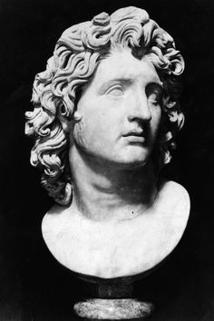 a bust of a man with curly hair and an inscription on the back of it