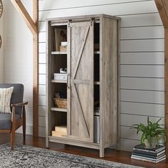 a living room with a chair and bookcase