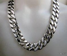 Formal Silver Stainless Steel Necklaces, Designer Silver Chain Jewelry, Designer Silver Jewelry With Silver Chain, Designer Sterling Silver Jewelry With Silver Chain, Luxury Silver Link Necklace, Luxury Silver Necklace With Curb Chain, Luxury Stainless Steel Necklace With Silver Chain, Luxury Silver Stainless Steel Chain Necklace, Designer Silver Metal Jewelry