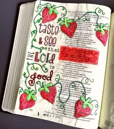 an open bible with strawberries on it