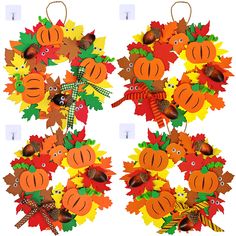 the wreaths are decorated with autumn leaves and acorns